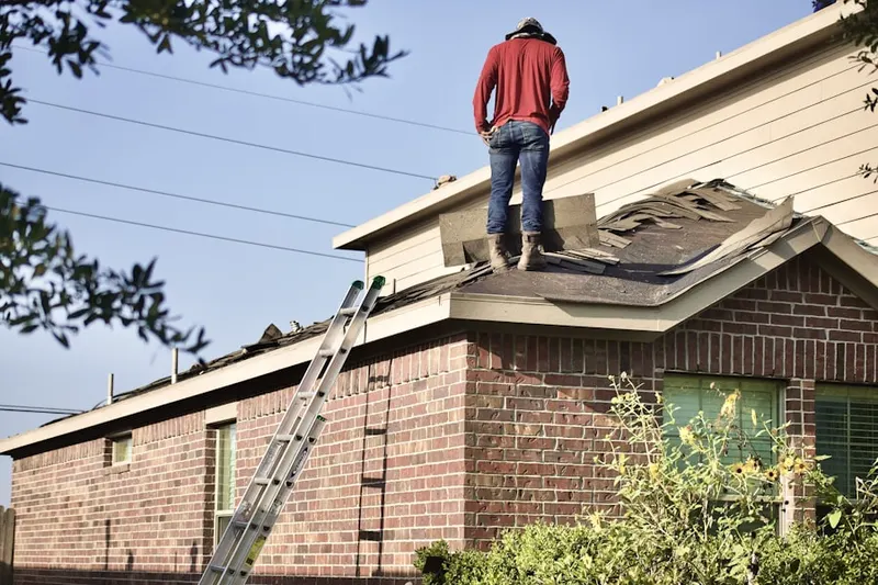 Professional roofer working on a residential roof in Avalon